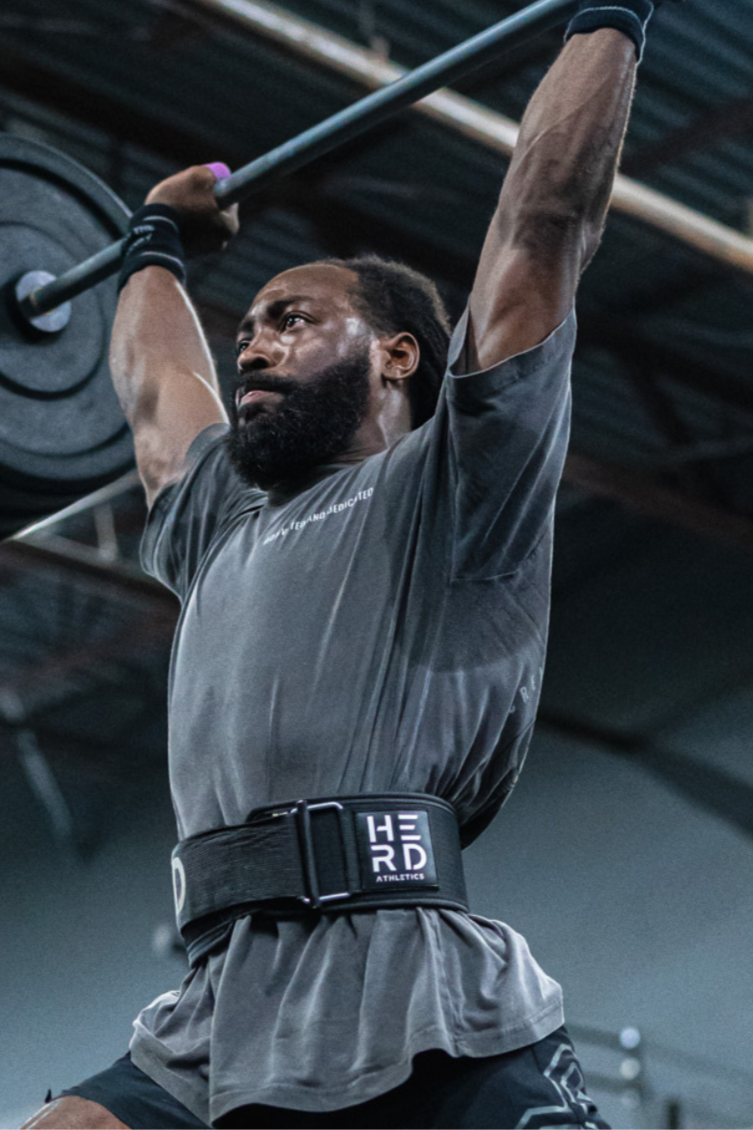 Person lifting a barbell with a focus on fitness and strength training.