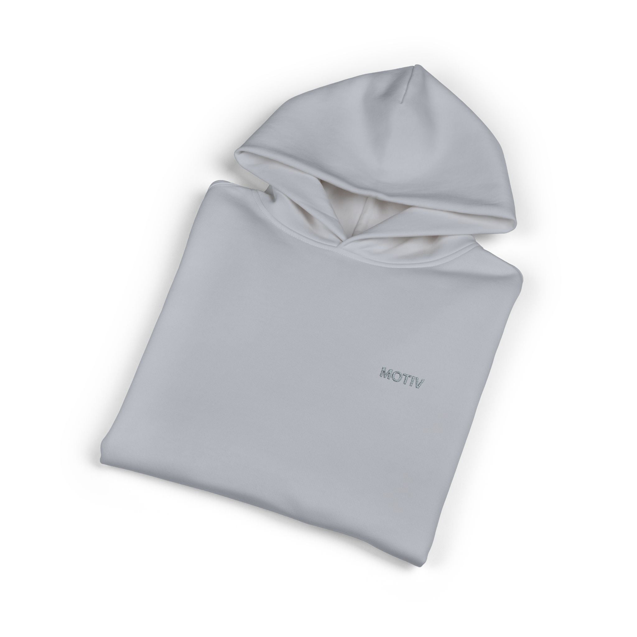 Folded light gray hoodie with 'MOTIV' branding on a white background