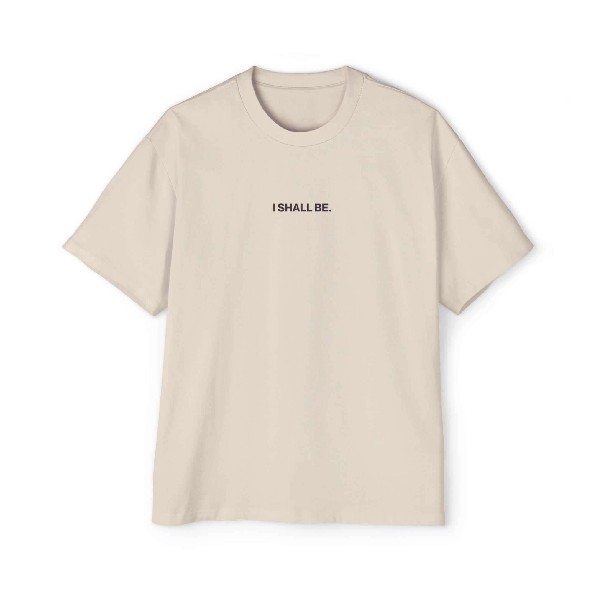 Beige t-shirt with 'I SHALL BE' text on a white background